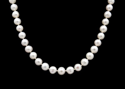 Lot 286 - A string of cultured white pearls with a 9ct ball clasp.