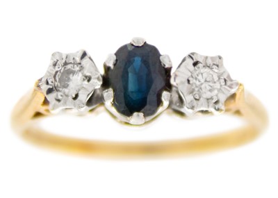 Lot 107 - A 9ct hallmarked diamond and sapphire set three-stone ring.