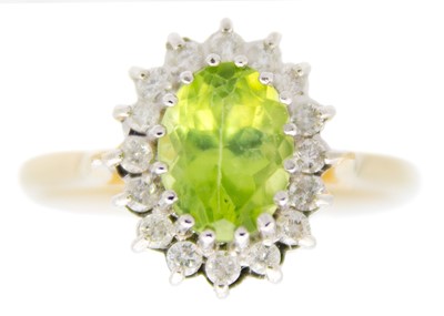 Lot 213 - A 9ct peridot and diamond set cluster ring.