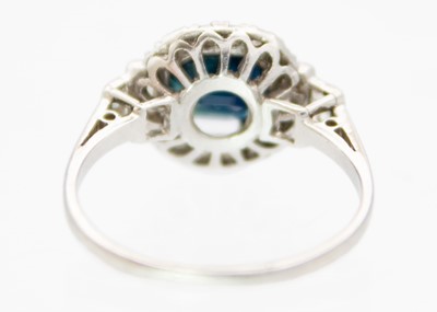 Lot 141 - An Art Deco platinum sapphire and diamond set cluster ring.