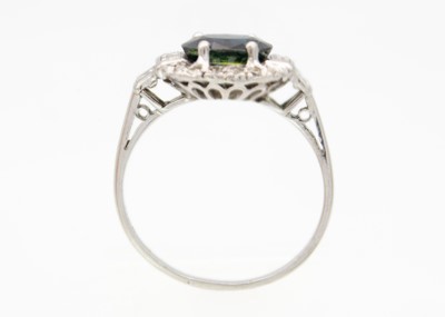 Lot 141 - An Art Deco platinum sapphire and diamond set cluster ring.