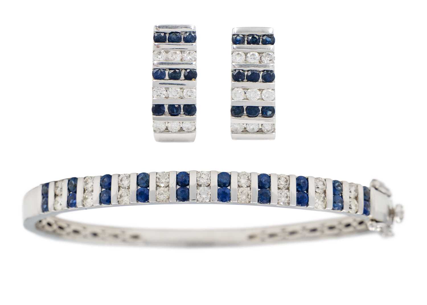 Lot 42 - A  good modern 14ct white gold diamond and sapphire set hinged bangle with matching earrings.