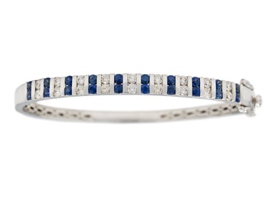 Lot 42 - A  good modern 14ct white gold diamond and sapphire set hinged bangle with matching earrings.