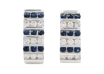 Lot 42 - A  good modern 14ct white gold diamond and sapphire set hinged bangle with matching earrings.