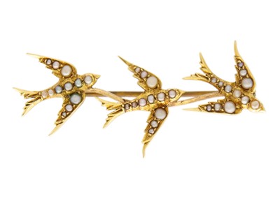 Lot 68 - An Edwardian high purity gold (tests 18ct) seed pearl set Swallows brooch.