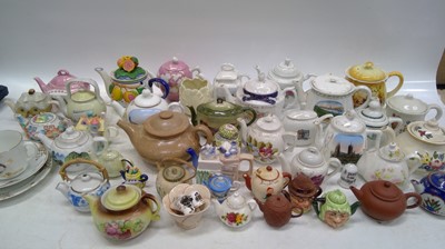 Lot 101 - A collection of teapots, some with local...