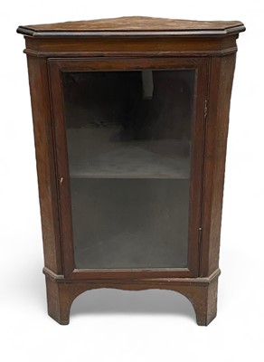 Lot 8 - A glazed oak standing corner cupboard