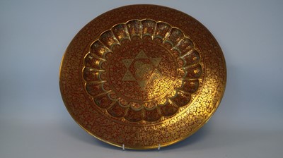 Lot 262 - An Indian red and brass charger, with a star...
