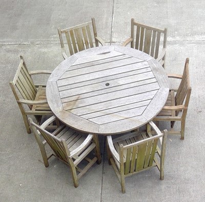 Lot 300 - A Teak Garden Table 155cm across with Six Teak...
