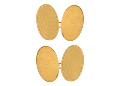 Lot 61 - A 9ct engine turned pair of oval cufflinks.