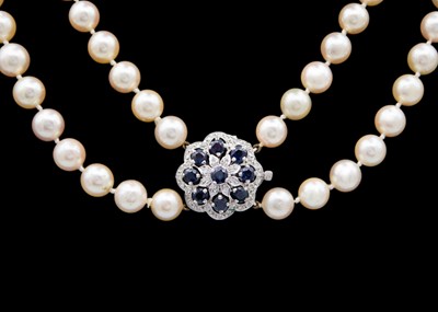 Lot 101 - A double-row cultured pearl Opera length necklace, 9ct white gold diamond & sapphire set clasp