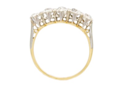 Lot 56 - An 18ct and platinum old mine cut diamond set five stone ring.