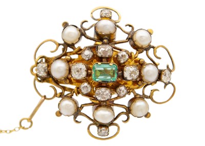 Lot 94 - An antique gold scroll brooch set with old mine cut diamonds, a central emerald and split pearls.