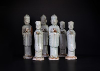 Lot 562 - Six Chinese celadon glazed pottery figures, probably Yuan Dynasty.