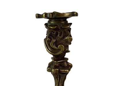 Lot 18 - A pair of French rococo style bronze candlesticks.