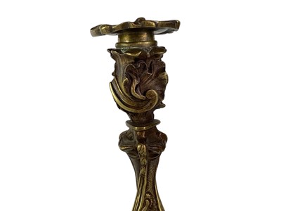 Lot 18 - A pair of French rococo style bronze candlesticks.