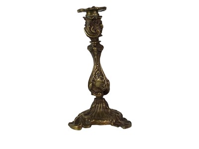 Lot 18 - A pair of French rococo style bronze candlesticks.
