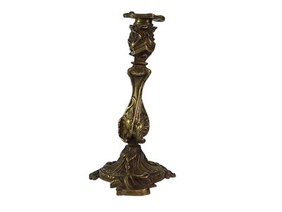 Lot 18 - A pair of French rococo style bronze candlesticks.