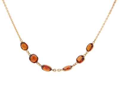 Lot 154 - A 9ct gold (tested) hessonite garnet set necklace.