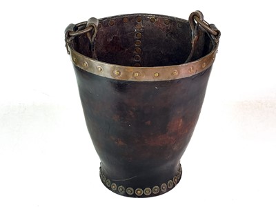 Lot 23 - A leather and copper bound riveted fire bucket.