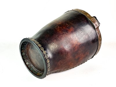 Lot 23 - A leather and copper bound riveted fire bucket.