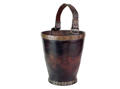 Lot 23 - A leather and copper bound riveted fire bucket.