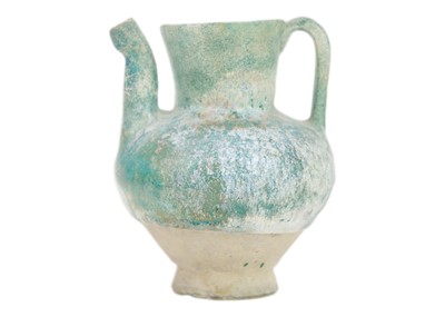 Lot 1072 - A Kashan turquoise glaze small spouted pot or ewer.
