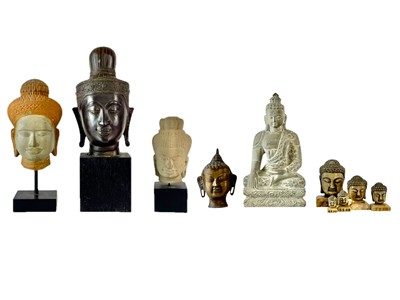 Lot 689 - A graduated set of five carved marble Buddha heads.