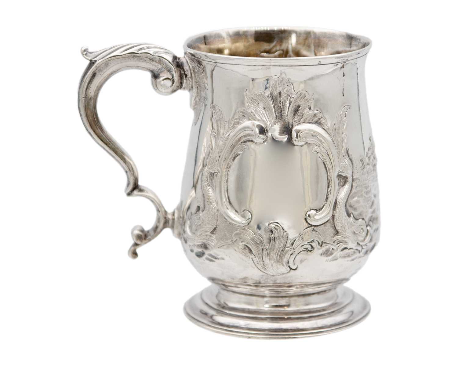 Lot 13 - A George III silver embossed baluster mug, London 1770.