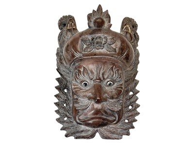 Lot 733 - A Chinese carved hardwood mask of a deity.