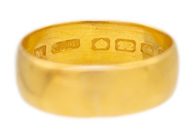 Lot 22 - A 22k yellow gold wide band ring.