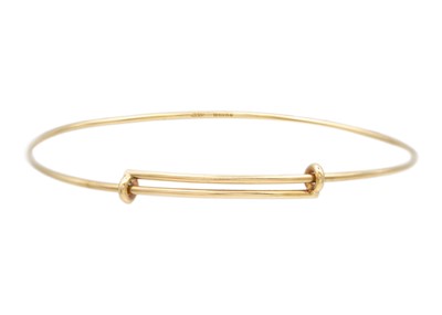 Lot 24 - A Tiffany & Co 9k gold adjustable wire bangle.