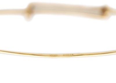 Lot 25 - A Tiffany & Co 9k gold adjustable wire bangle.