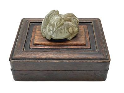 Lot 647 - A Chinese carved jade group of two entwined lion dogs.