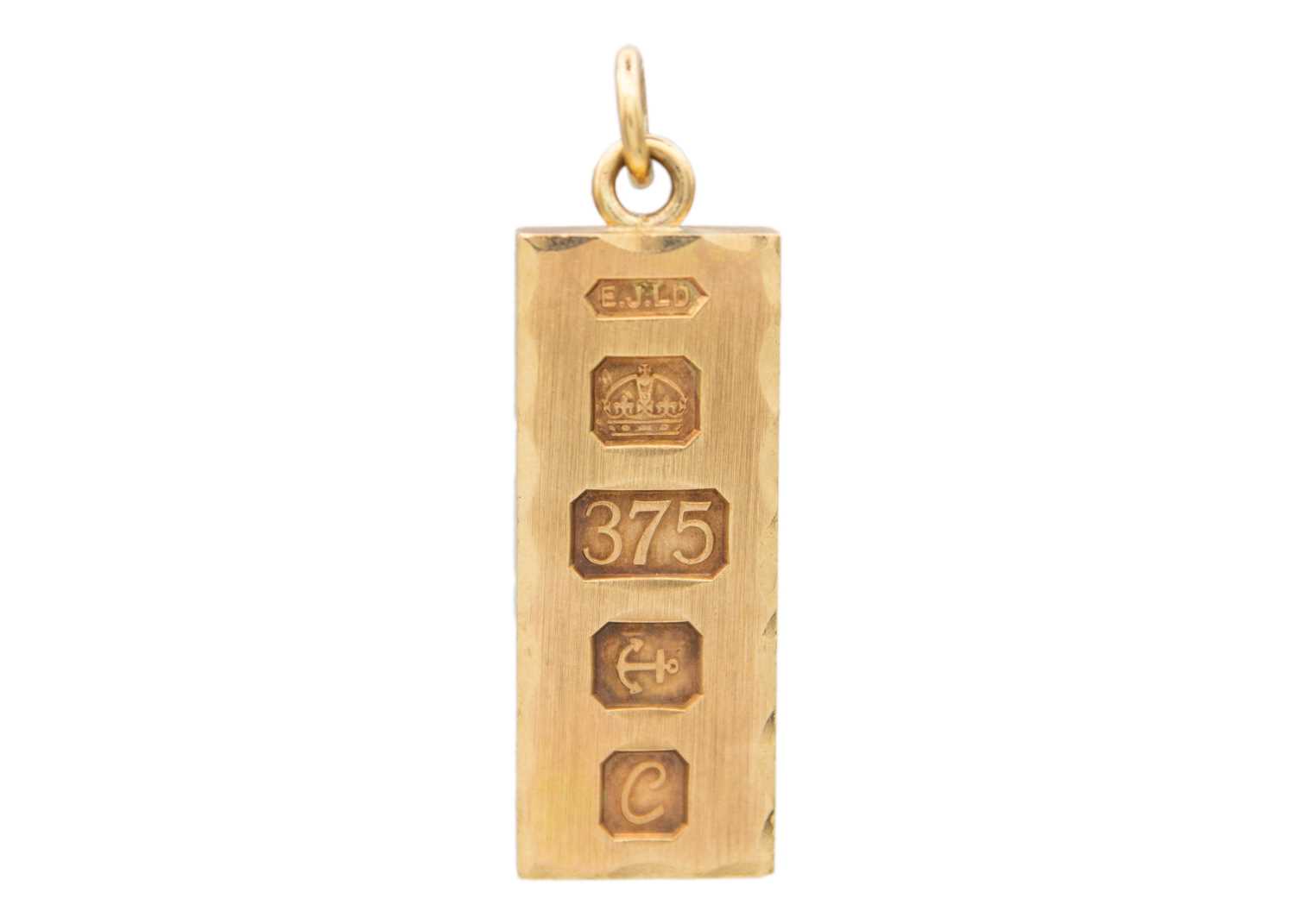 Lot 26 - A 9k gold ingot pendant.