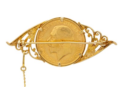 Lot 29 - A full sovereign encased in a 9k gold brooch.