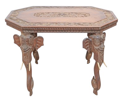 Lot 451 - A carved hardwood table with Indian elephant head decoration.
