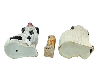 Lot 34 - A clay figure of a bearded man holding a tome.
