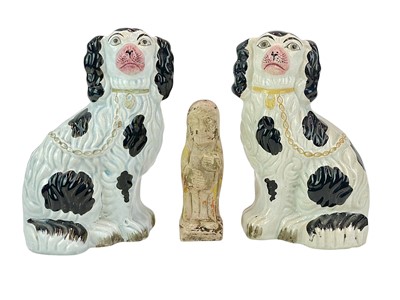 Lot 34 - A clay figure of a bearded man holding a tome.