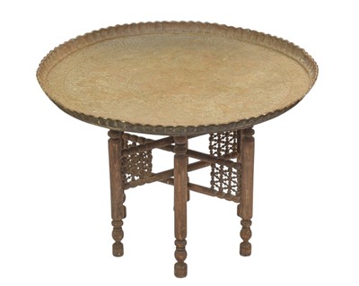 Lot 498 - An Indian circular brass table on a folding wooden stand.