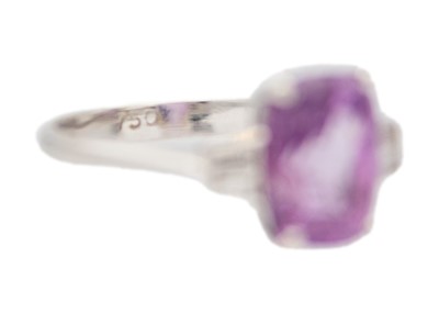 Lot 12 - A purplish pink sapphire and diamond set white gold ring.