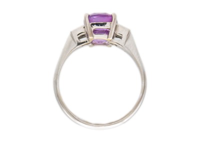 Lot 12 - A purplish pink sapphire and diamond set white gold ring.