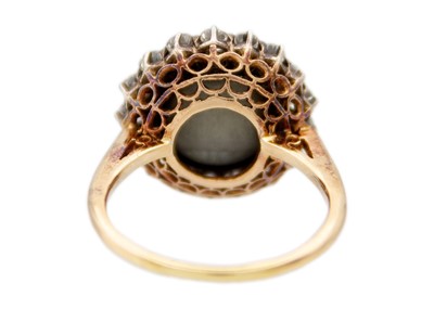 Lot 1 - A late Victorian cat's eye chrysoberyl and diamond halo yellow gold ring.