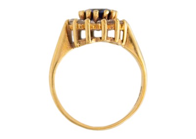 Lot 45 - A 9k gold synthetic sapphire and CZ halo ring.