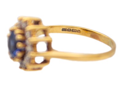 Lot 45 - A 9k gold synthetic sapphire and CZ halo ring.
