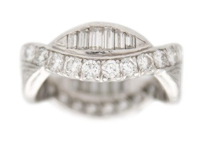 Lot 11 - A diamond fancy crossover band ring in platinum.