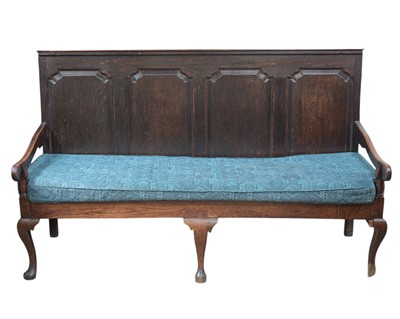 Lot 444 - An oak settle with a quadruple fielded panel back.