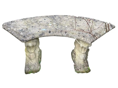 Lot 343 - A curved reconstituted stone bench.