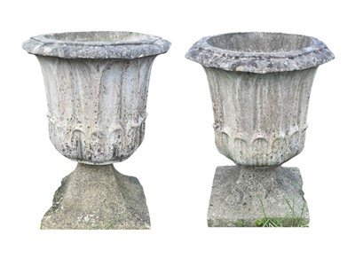 Lot 357 - A pair of reconstituted stone urns on matched swept bases.