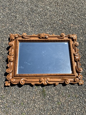 Lot 3028 - An elaborately carved hardwood mirror. 132cm x...